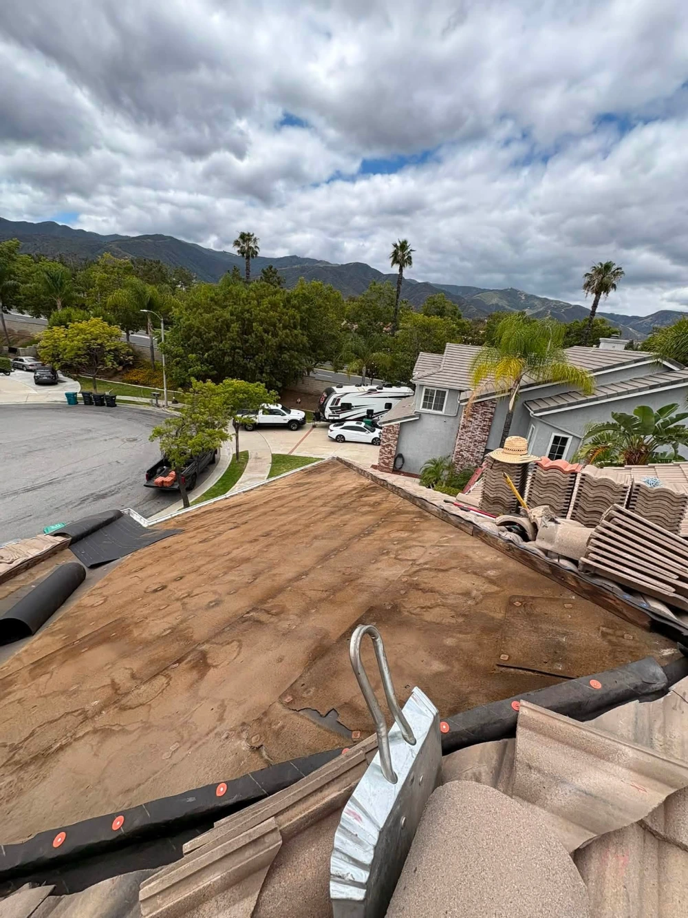 Clearing debris from flat roof drain before rainy season
